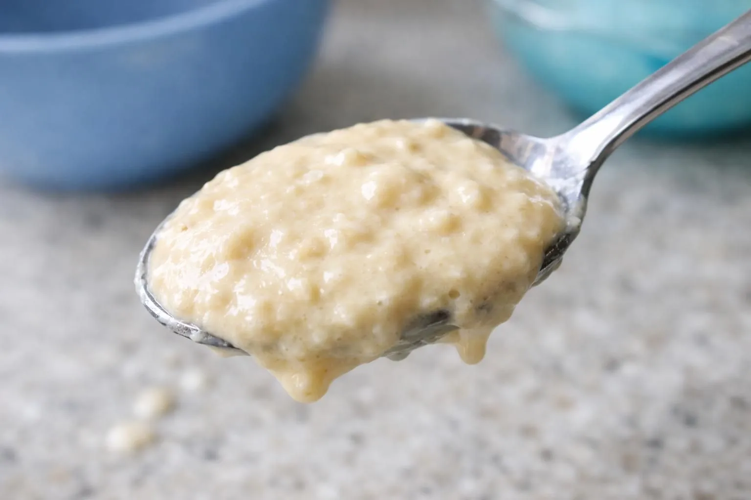 Creamy oatmeal with melted butter on a spoon.